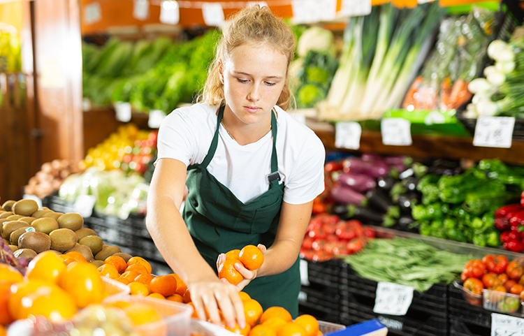 Teenager working in the produce area